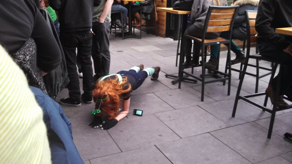 Young lady doing push-ups randomly at Jack Rose's St. Patrick's Day Celebration 